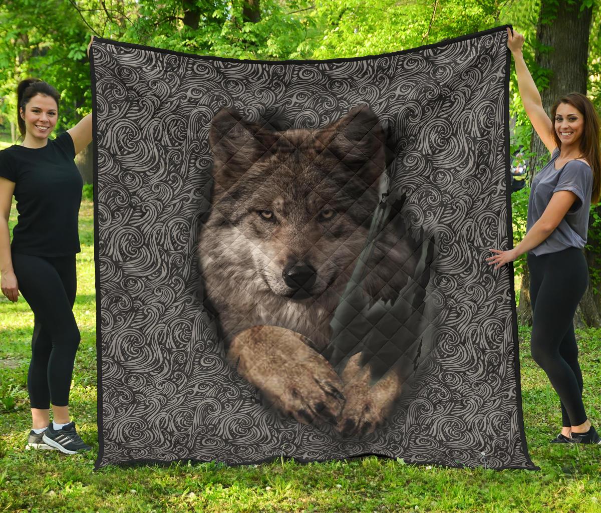 Black and gray quilt with wolf portrait centered and swirling pattern border, quilted texture
