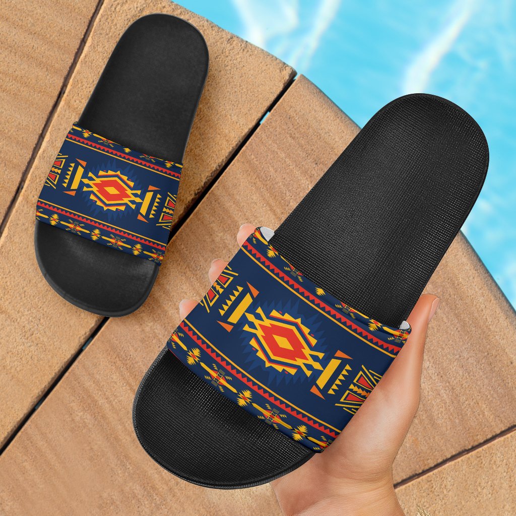 Blue ethnic slide sandals with black footbed and multicolor patterned strap