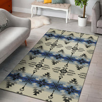Cream geometric area rug with blue bands, black/gray triangles, and tribal cross motifs