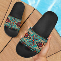 Tribe blue pattern slide sandals with black textured sole and colorful Native-style strap