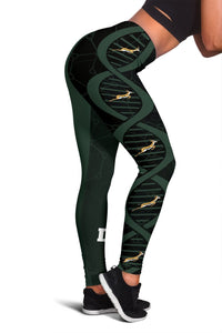 Green-and-black leggings with repeating springbok graphic and circular DNA-style motif