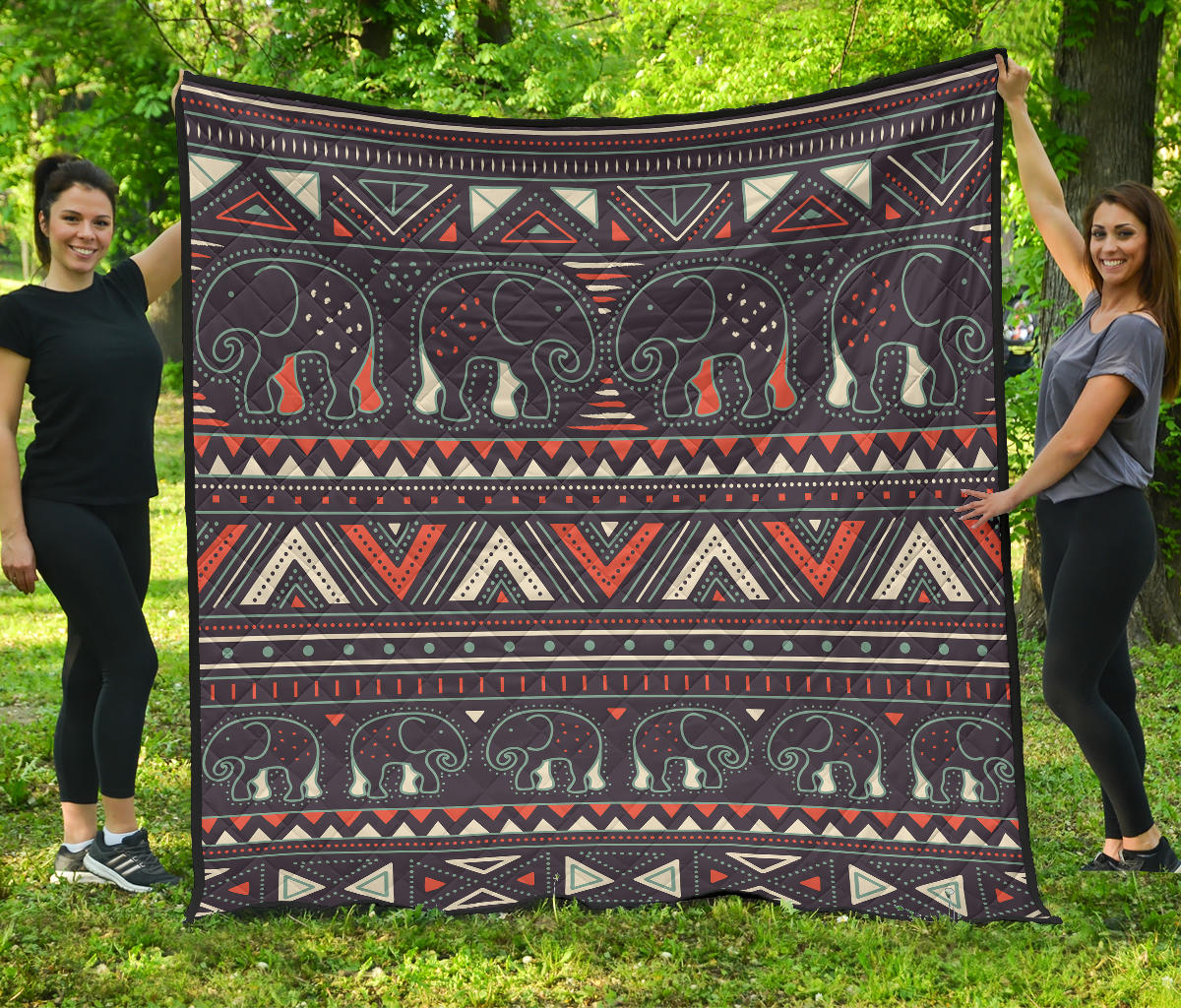 Multicolor tribal elephant quilt with geometric bands and dark background, flat view