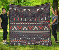 Multicolor tribal elephant quilt with geometric bands and dark background, flat view