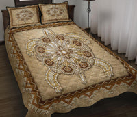 Beige Native American quilt bed set with gold-toned beaded medallion and matching pillows