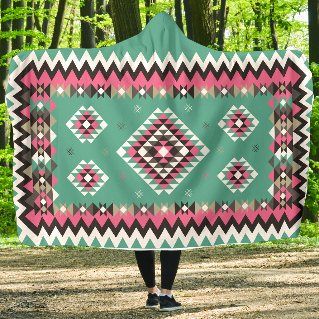 Teal hooded blanket with pink geometric Native-style pattern and white trim