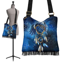Blue dreamcatcher crossbody bag with fringe trim and adjustable shoulder strap.