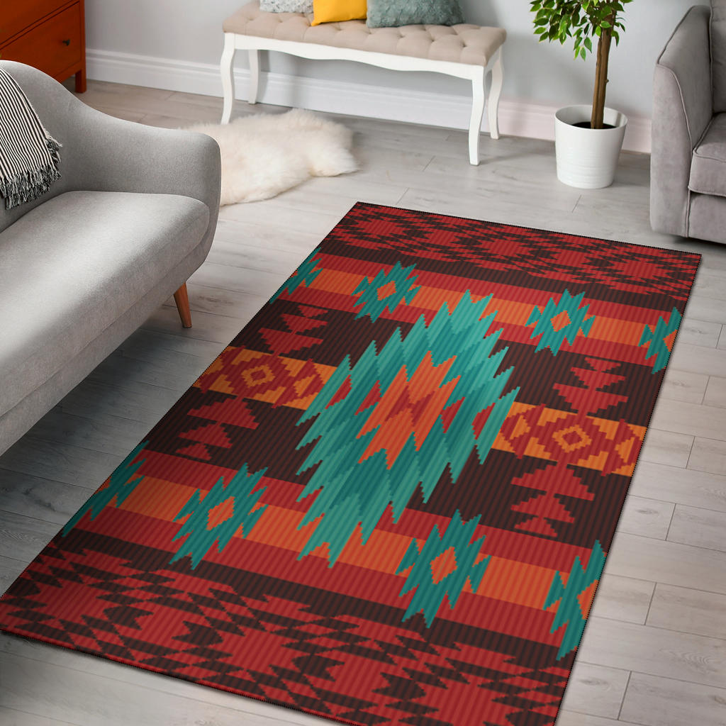 Red geometric area rug with teal, orange, and yellow diamond and zigzag pattern.