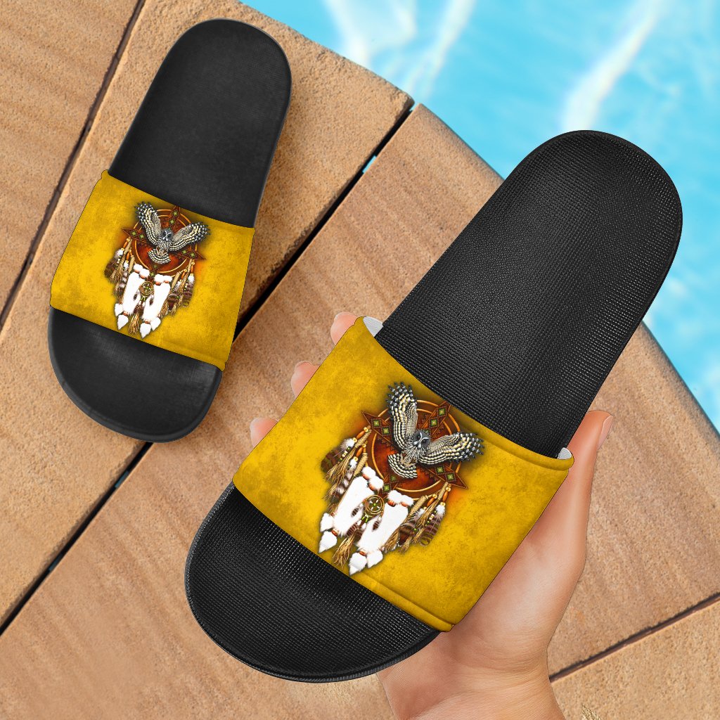 Yellow slide sandals with black footbed and owl graphic on the strap