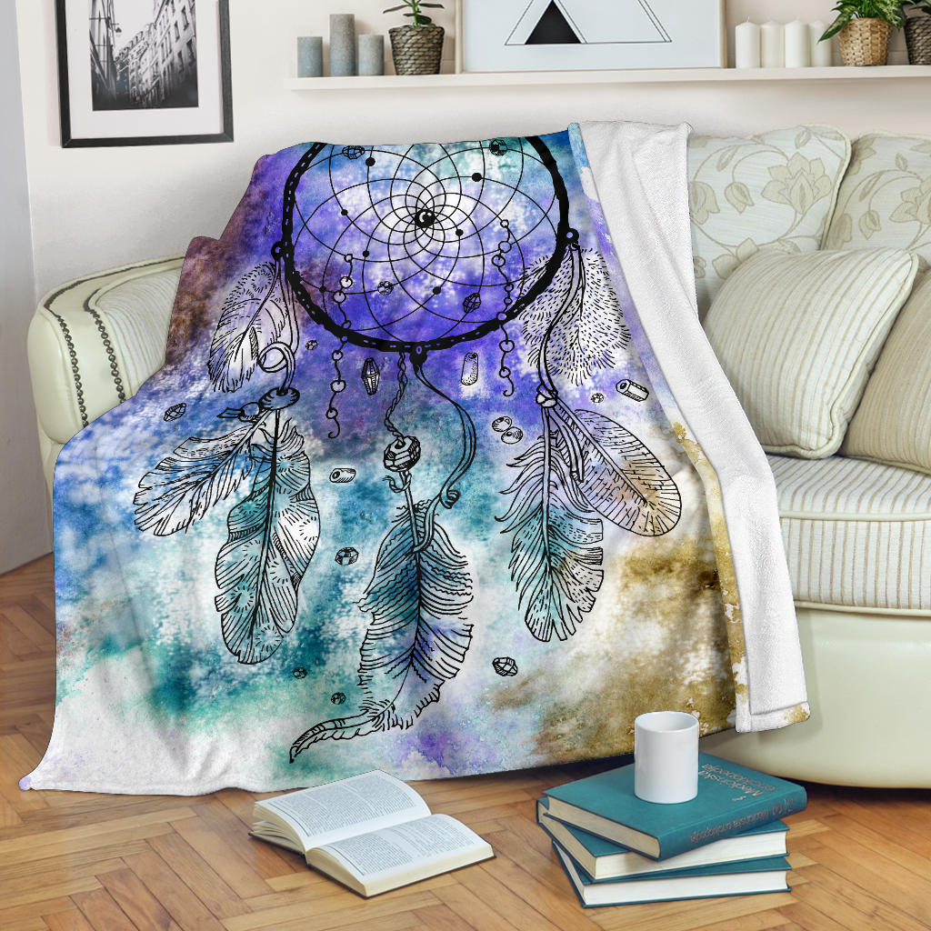 Multicolor dream catcher blanket with purple-blue feathers and web motif, draped on bed