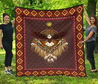 Multicolor native-style quilt with eagle and sun symbol, geometric diamond border, burgundy