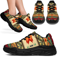 Native geometric chunky sneakers, beige upper with colorful pattern and black rubber sole, black laces