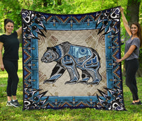 Bear symbol Native American quilt with blue border, black/white bear and tan geometric trim