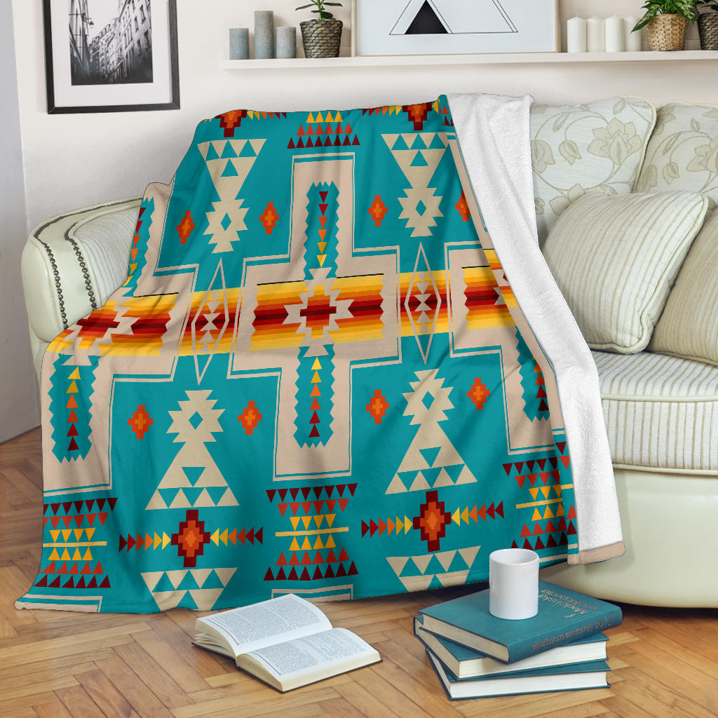 Turquoise tribal design blanket with multicolor geometric cross and arrow motifs
