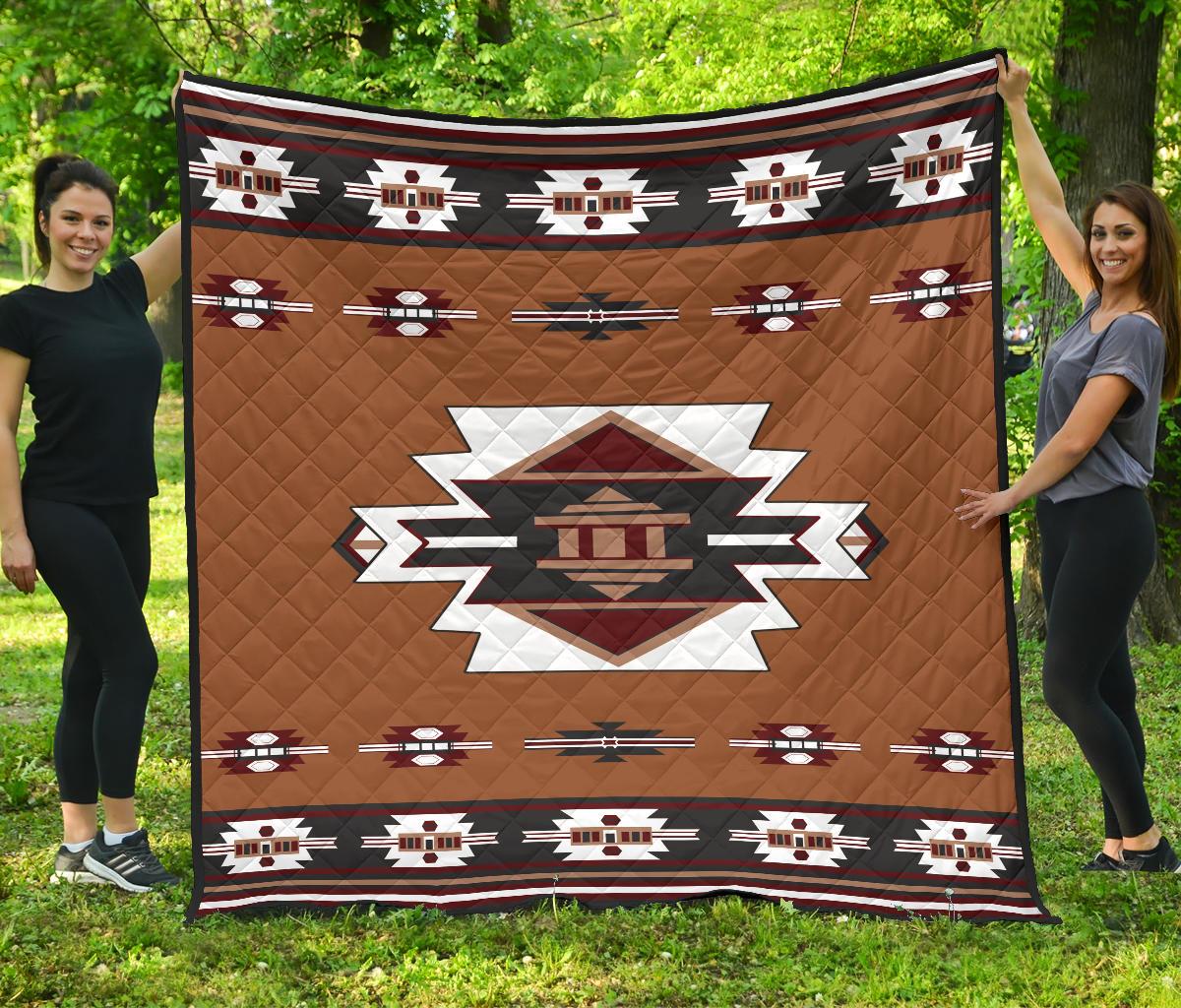 Native American style quilt with brown diamond stitching and geometric stripe border
