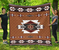 Native American style quilt with brown diamond stitching and geometric stripe border