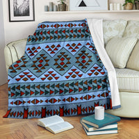Blue patterned premium blanket with multicolor geometric stripes, folded with white backing