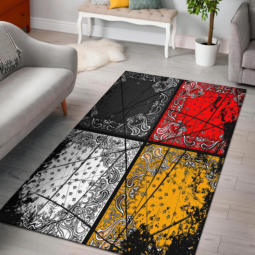 Multicolor area rug with black patchwork panels and paisley bands in red, yellow, and white