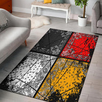 Multicolor area rug with black patchwork panels and paisley bands in red, yellow, and white