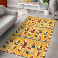 Yellow area rug with colorful feather pattern and decorative border lines