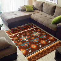 Brown geometric area rug with colorful triangles, borders, and scattered white birds