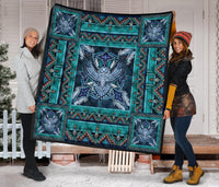 Multicolor Native-inspired quilt with teal ground, blue eagle-style medallion, and side panels