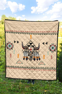 Cream quilt blanket featuring central bison head and colorful geometric bands