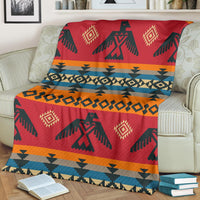 Red geometric Native-style blanket with orange and teal stripes and diamond motifs