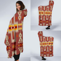 Red-brown hooded blanket worn by model, patterned poncho with hood