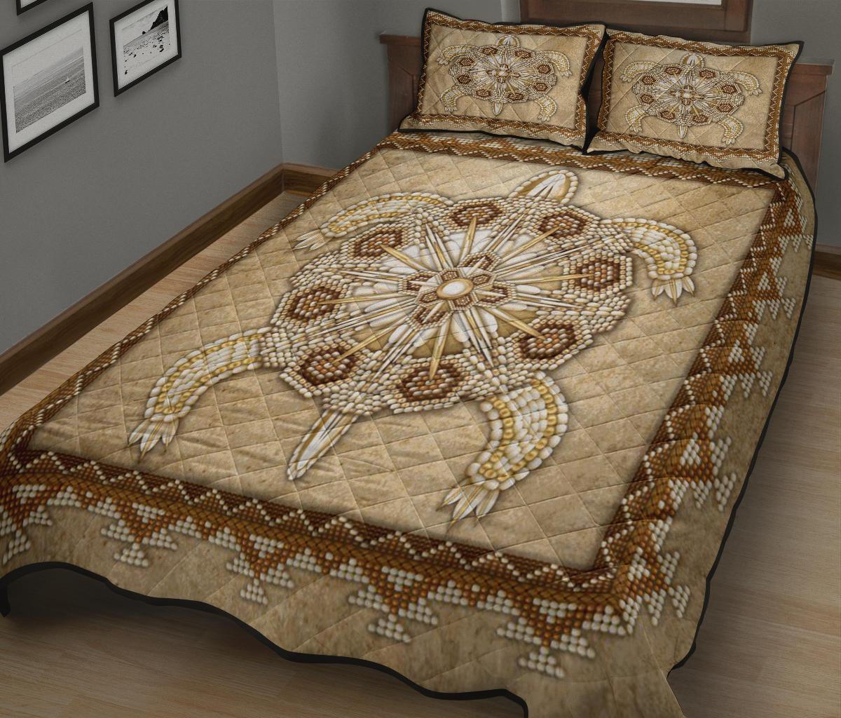 Beige quilt bed set featuring central starburst medallion and patterned border; two pillows