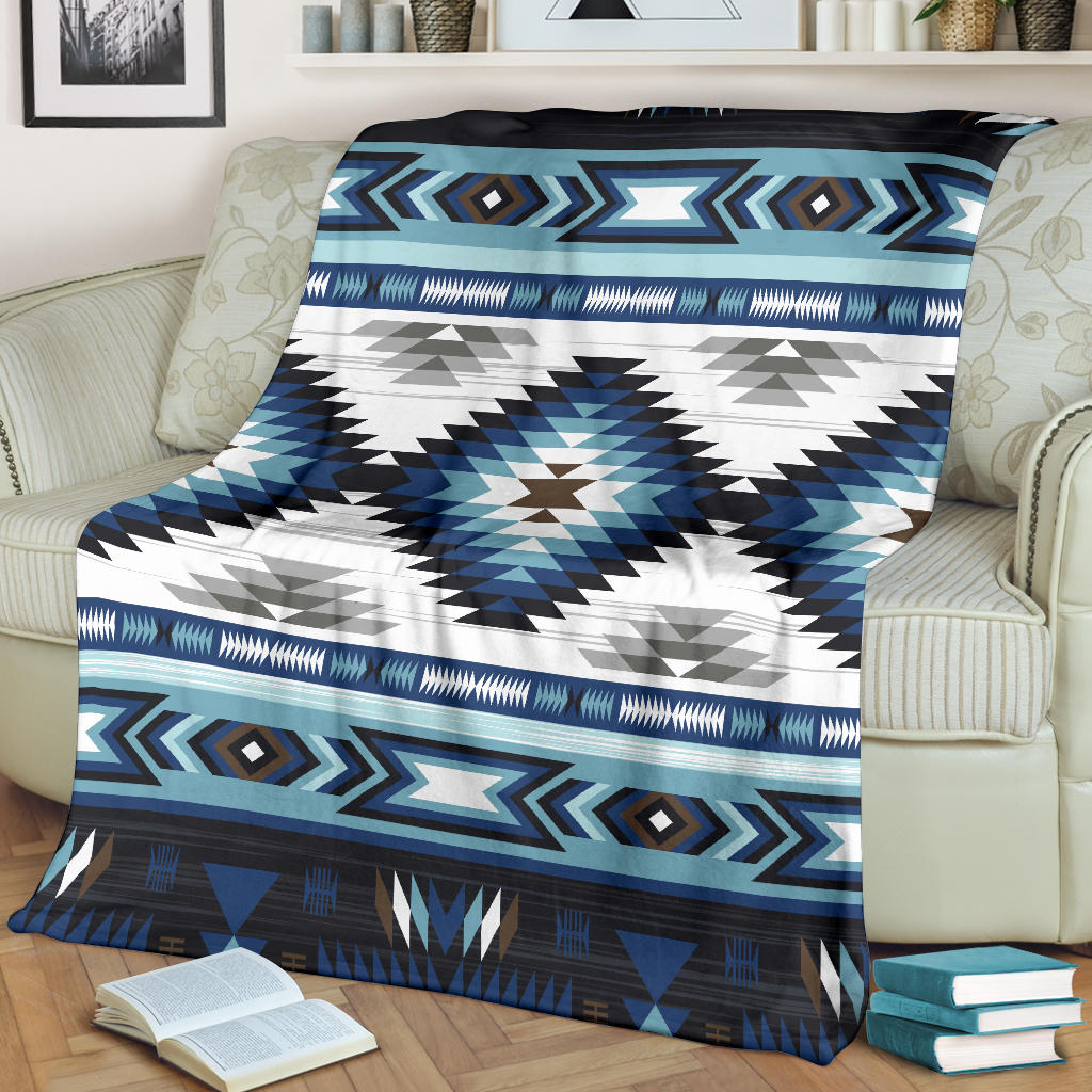 Tribal pattern blanket in blue and white with large star-like center and striped band