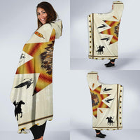 Native hooded blanket folded and held; chief starburst, horses, arrows, and feather prints