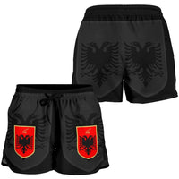 Black women’s shorts with elastic waistband and red Albanian crest graphics, front and back