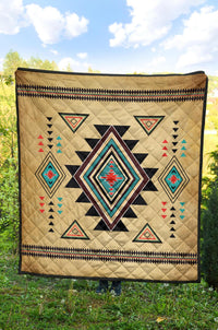 Tan quilt with colorful Native southwest geometric motifs, central star-diamond and patterned edge.