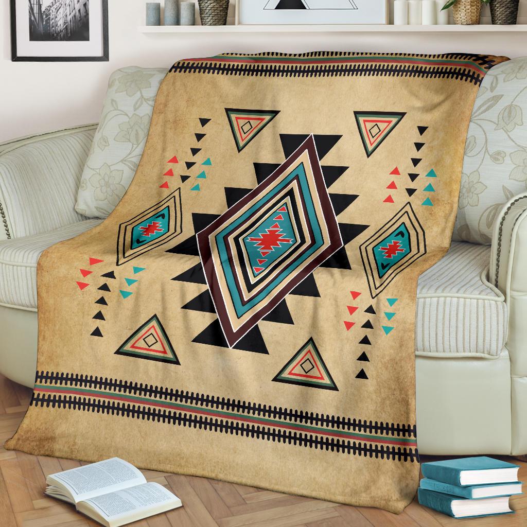 Tan Southwest symbol blanket with central multicolor diamond and small outlined triangle motifs