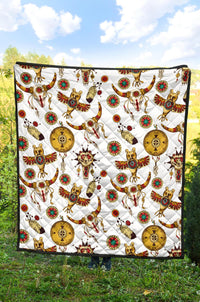 Native American totems quilt showing white fabric with multicolor animal and coin designs