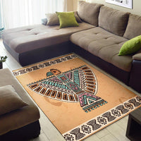 Beige tribal symbol area rug with colorful geometric accents and black-and-white border strip