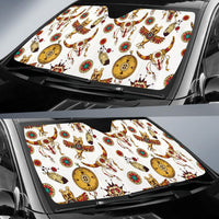 Multicolor Native American style windshield sun shade on car, featuring animals and medallions