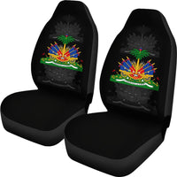 Two black front seat covers with Haiti multicolor graphic, matched set