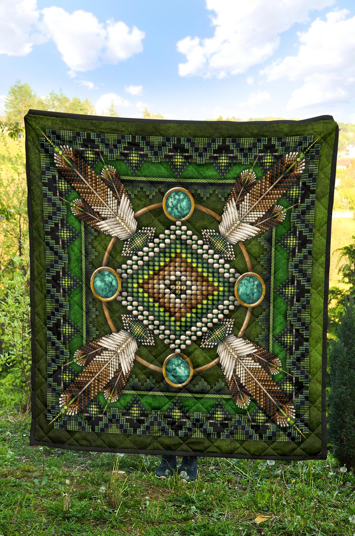 Green Native American mandala quilt laid out flat, beadwork pattern and turquoise medallions.