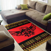 Red rug with black frame and gold geometric trim, eagle motif
