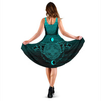 Back view teal sleeveless dress with dark skirt and teal circular Norse design