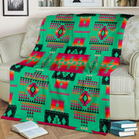 Light green multicolor geometric blanket draped on sofa with red and teal motifs