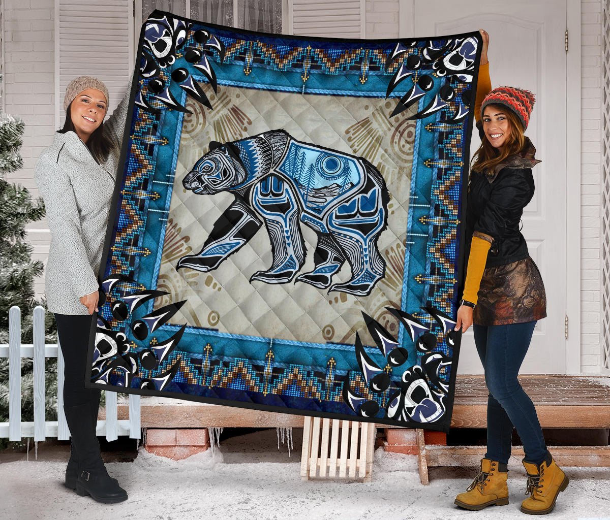 Multicolor quilt featuring a blue-toned bear graphic and Native American-style geometric border
