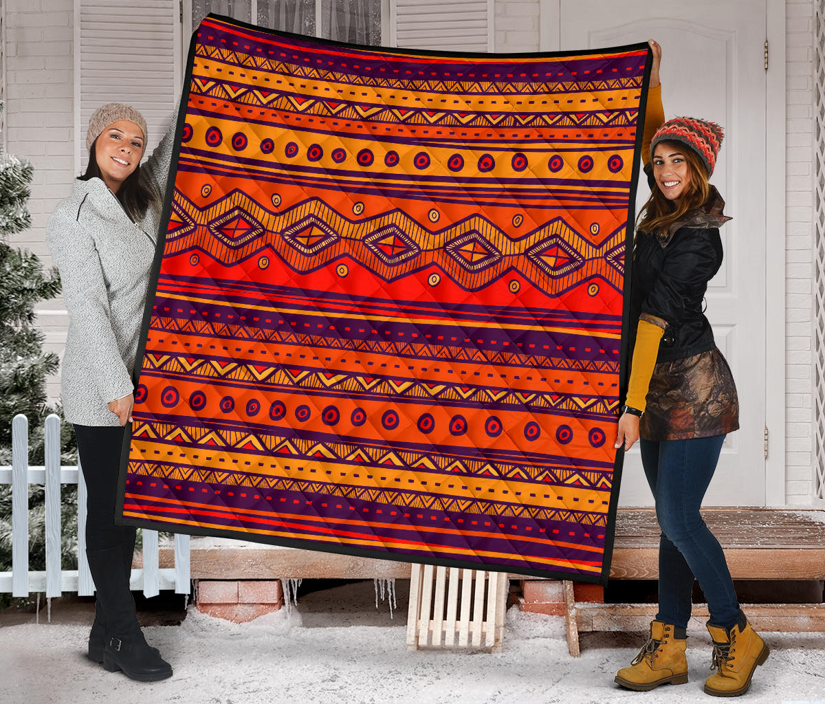 Orange patterned quilt with repeating navy circle outlines and diamond motifs, bordered in dark trim