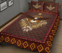 Burgundy quilt with central dreamcatcher bird motif and patterned border, two pillow set