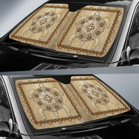 Two-piece tan sun shade set with beadwork flower motifs laid across windshield