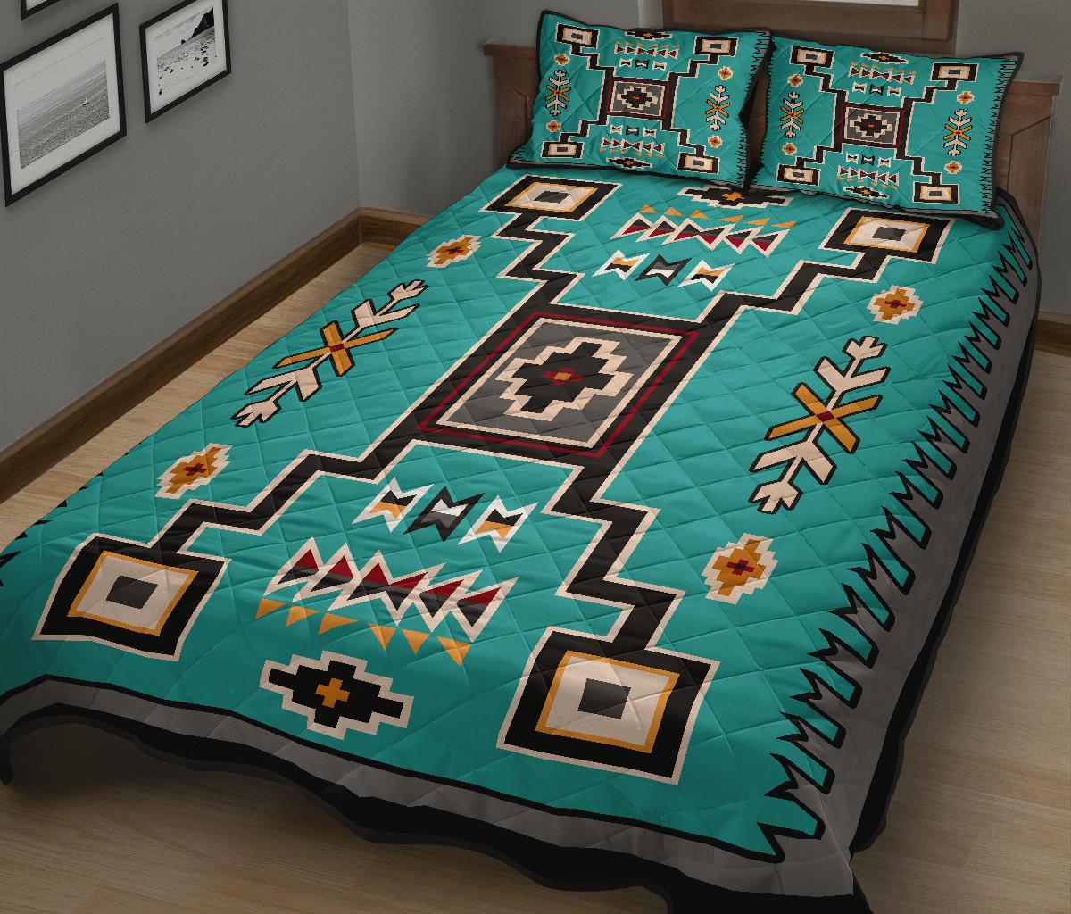 Teal Native geometric quilt with central medallion, zigzags, and cross shapes; matching pillowcases