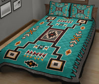 Teal Native geometric quilt with central medallion, zigzags, and cross shapes; matching pillowcases