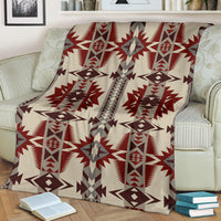 Cream blanket with bold red and gray geometric star and column design