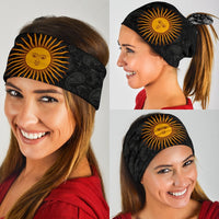 Black sun-pattern neck gaiter/headband with orange sun-face graphic